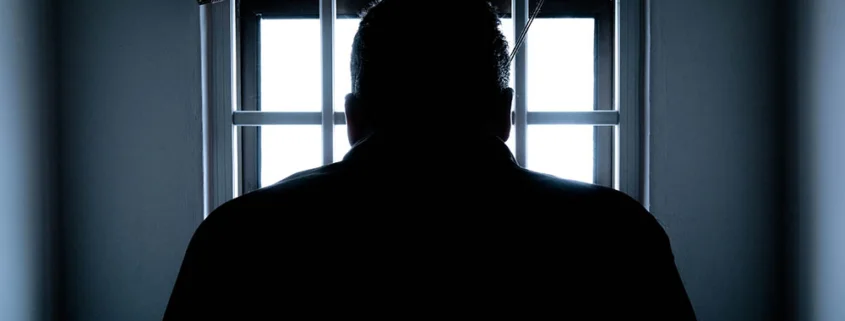 silhouette of a man in window mediano